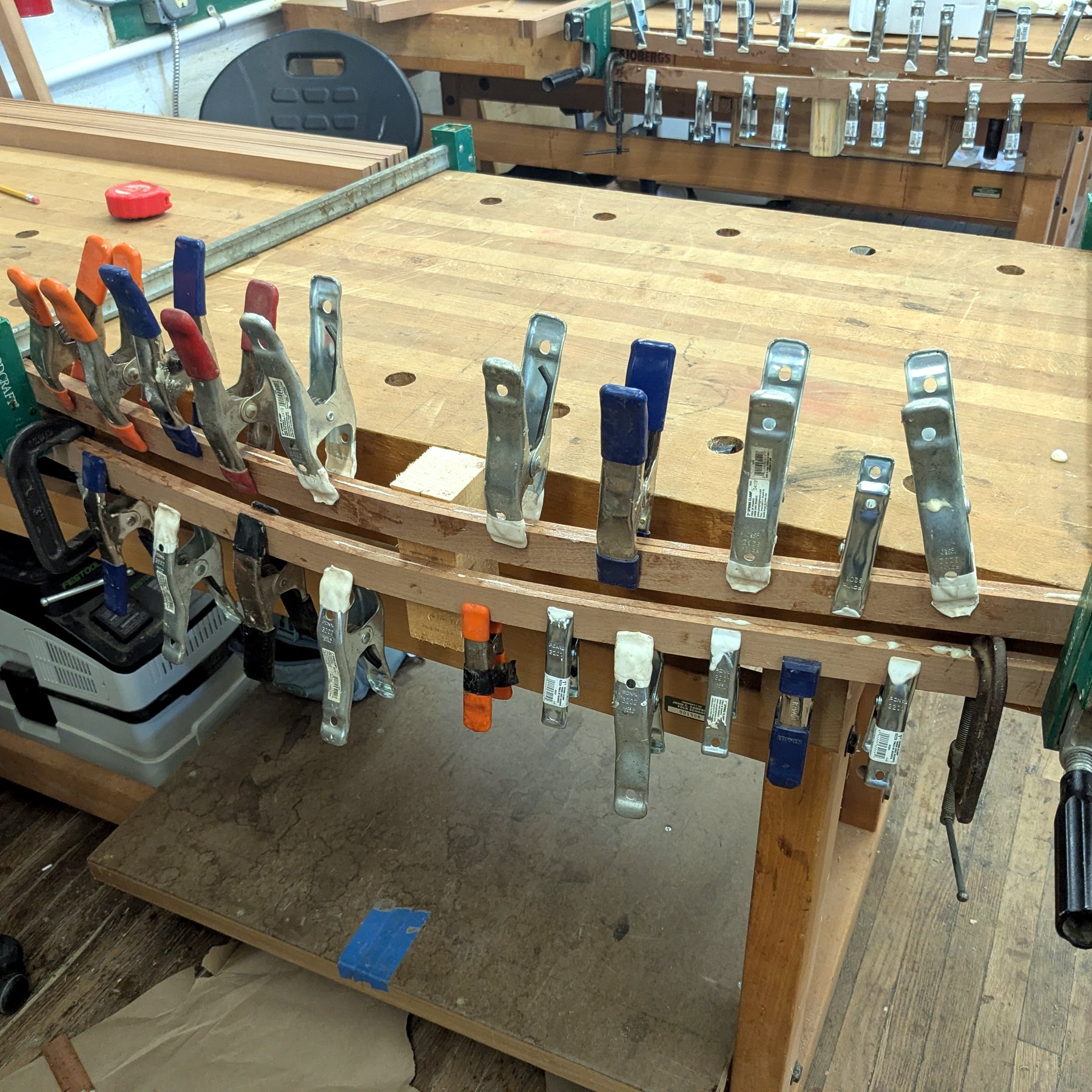 Workbench Glue-Up - Row of clamps on a curved lamination