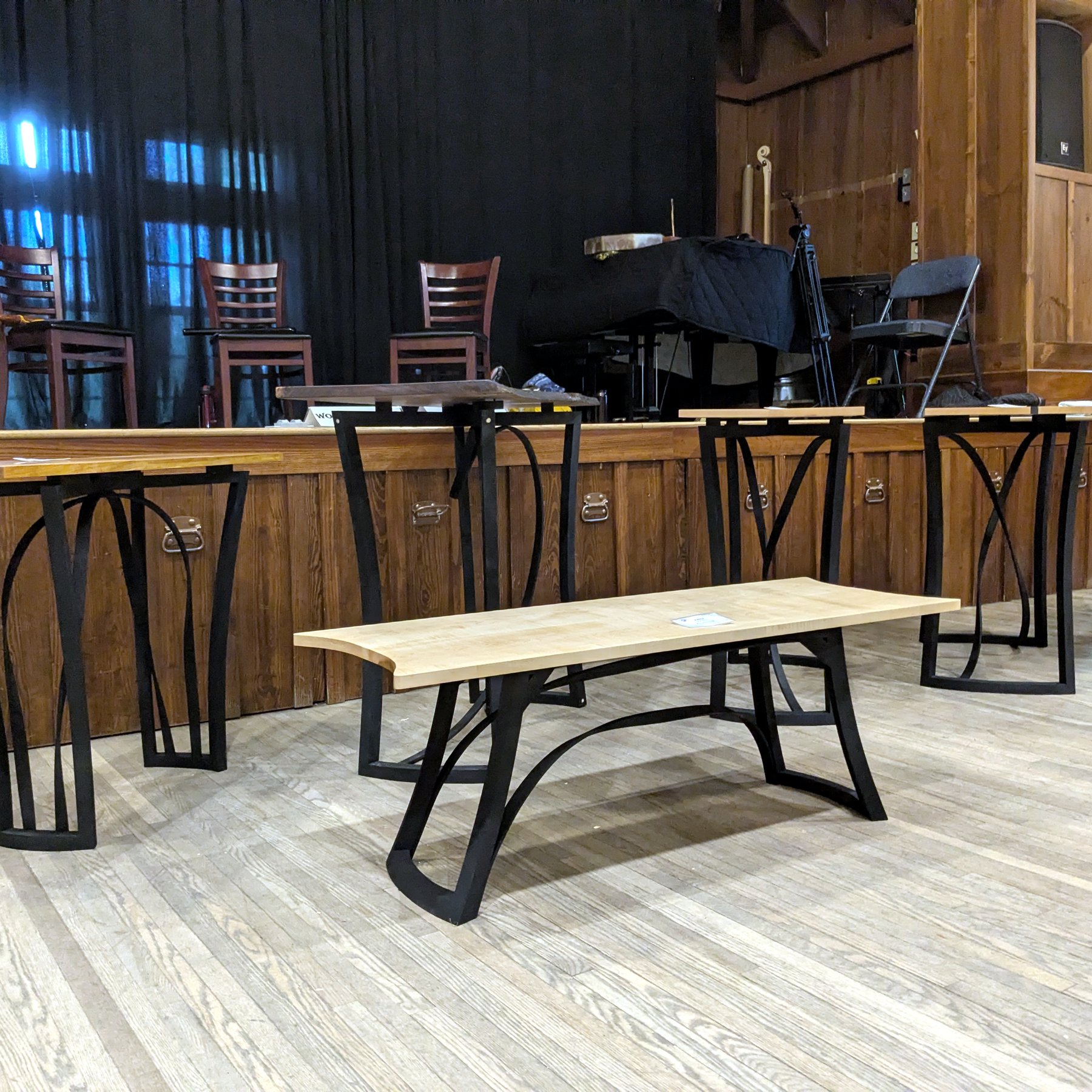 Live-Edge Bench - Finished bench with black steel legs in a performance venue
