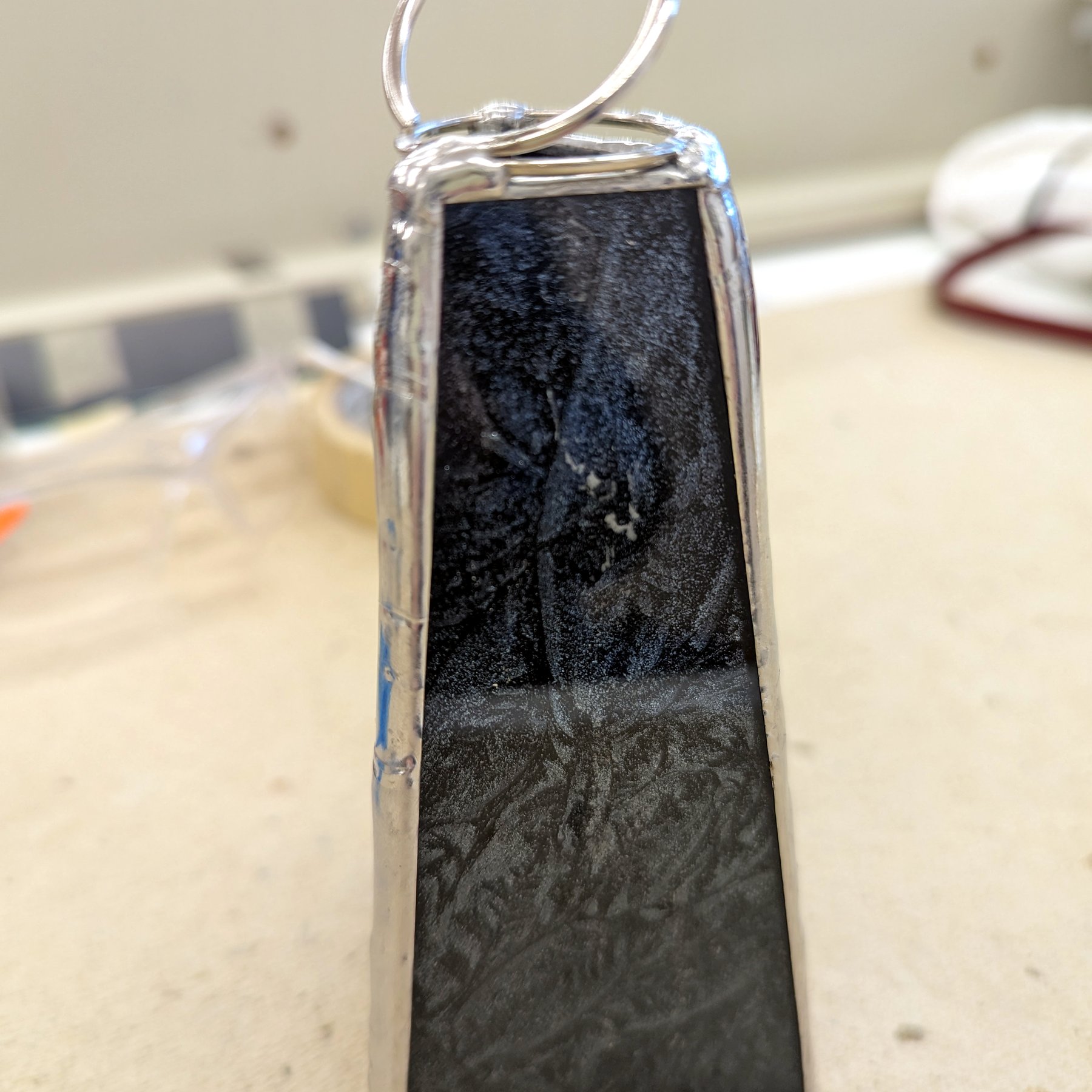 Black Stone Pendant Scope - Silver-framed kaleidoscope pendant with black stone and wire bail